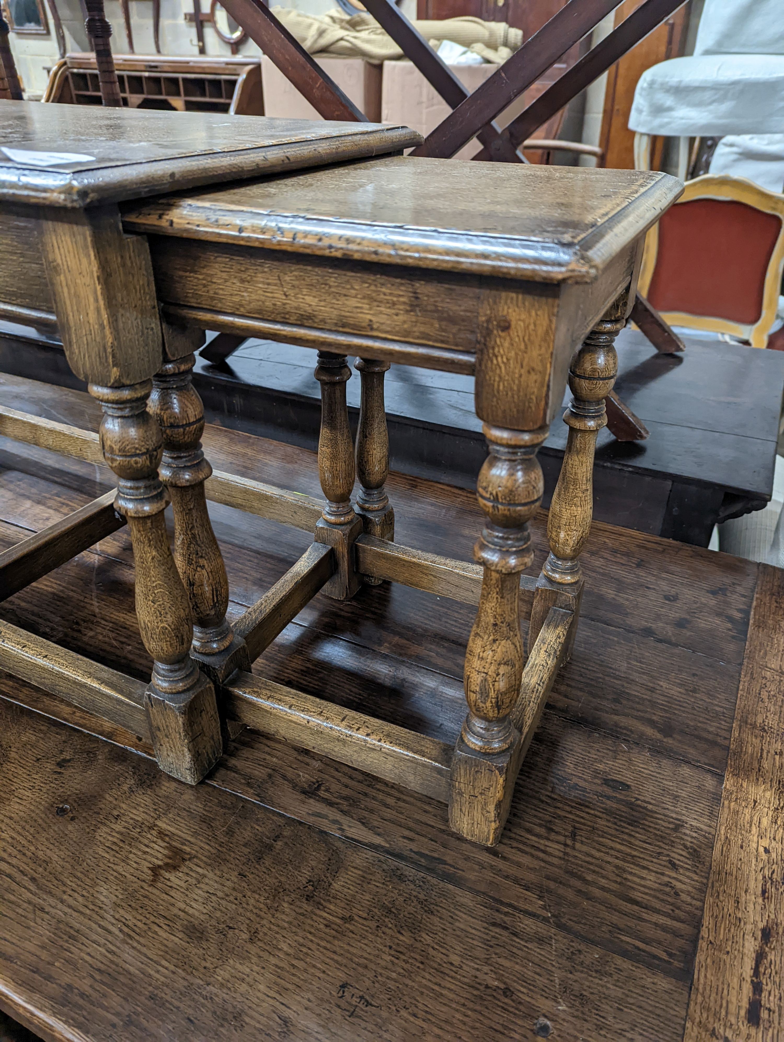 A nest of 18th century oak occasional tables, width 101cm, depth 38cm, height 46cm